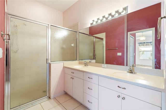 bathroom with a stall shower, tile patterned flooring, and a sink