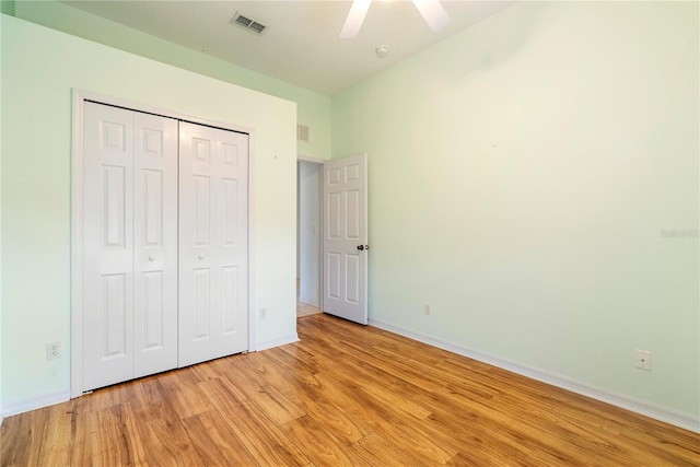 unfurnished bedroom featuring a closet, visible vents, baseboards, and light wood finished floors