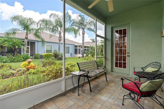 sunroom / solarium featuring a ceiling fan