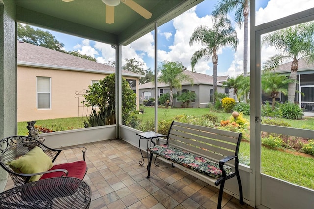 sunroom featuring a ceiling fan