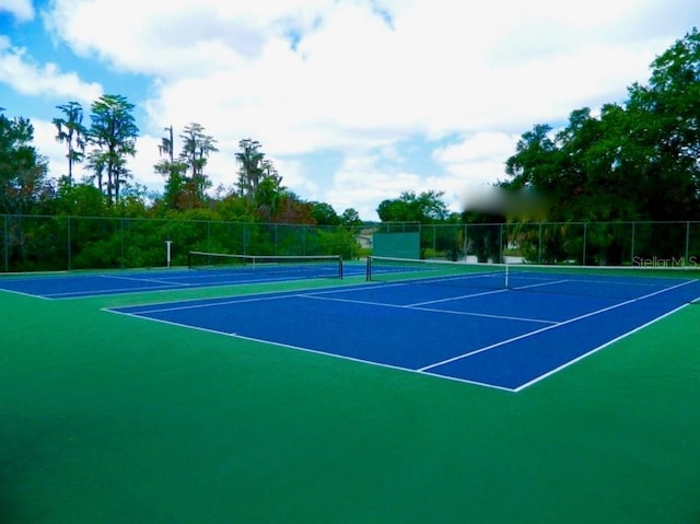 view of sport court with fence