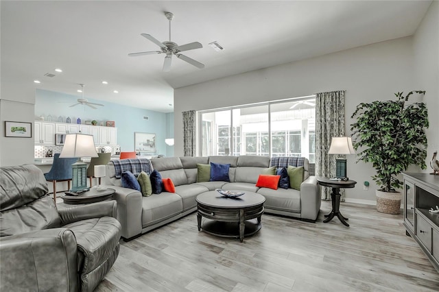 living room featuring ceiling fan and light hardwood / wood-style flooring