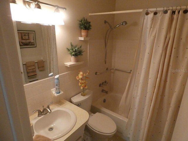 full bathroom with decorative backsplash, shower / tub combo, vanity, and toilet