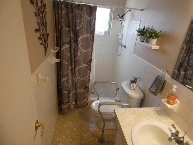 bathroom featuring curtained shower, tile patterned floors, toilet, vanity, and tile walls