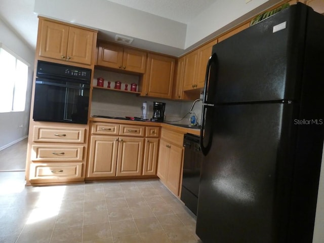 kitchen with light tile patterned flooring and black appliances