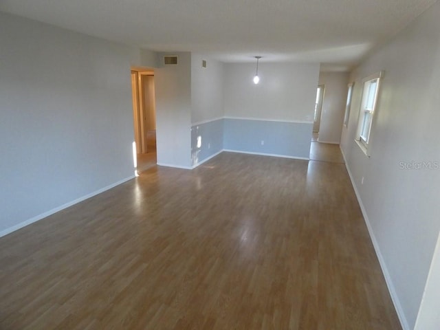 spare room featuring wood-type flooring