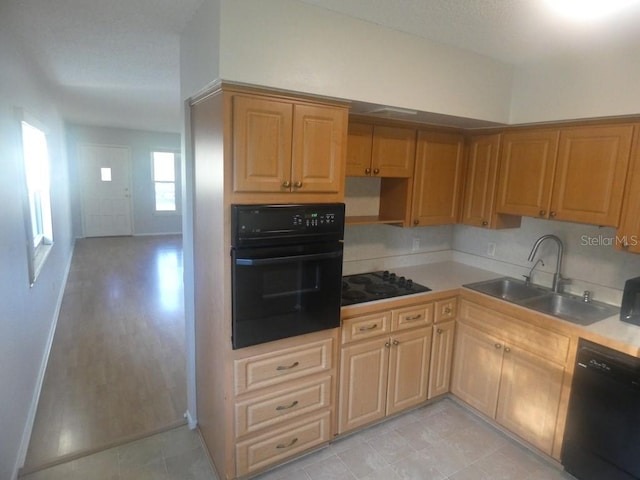 kitchen featuring sink and black appliances