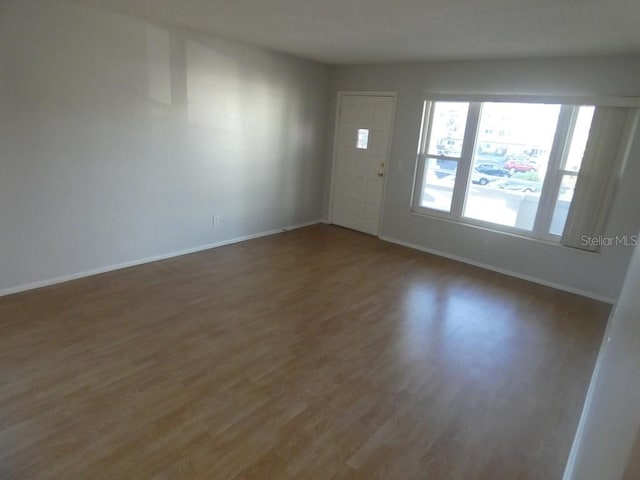 unfurnished room featuring dark wood-type flooring