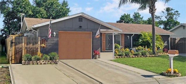 view of front of property featuring a front yard and a garage