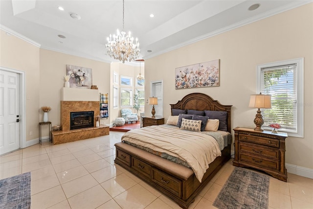 bedroom featuring light tile patterned floors, a notable chandelier, a high end fireplace, baseboards, and a tray ceiling