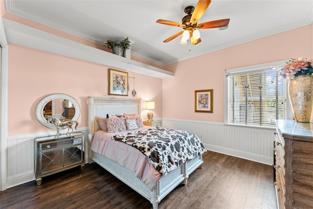 bedroom featuring hardwood / wood-style flooring, ceiling fan, crown molding, and wainscoting