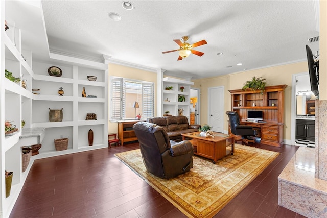 living room with a textured ceiling, dark wood-style flooring, and built in features