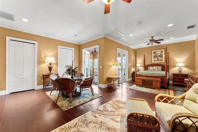 bedroom with dark wood-style flooring, visible vents, and crown molding