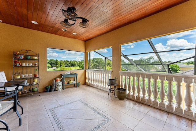 sunroom / solarium featuring lofted ceiling and wood ceiling