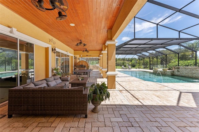 pool with glass enclosure, an outdoor hangout area, a ceiling fan, and a patio