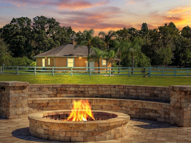 exterior space with fence private yard, an outdoor fire pit, and a lawn