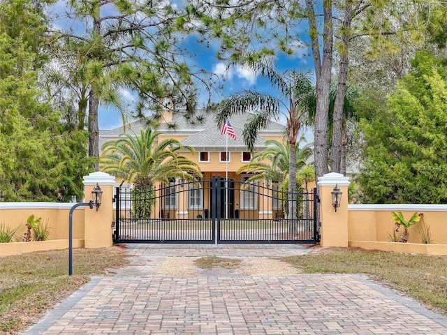view of gate with a fenced front yard