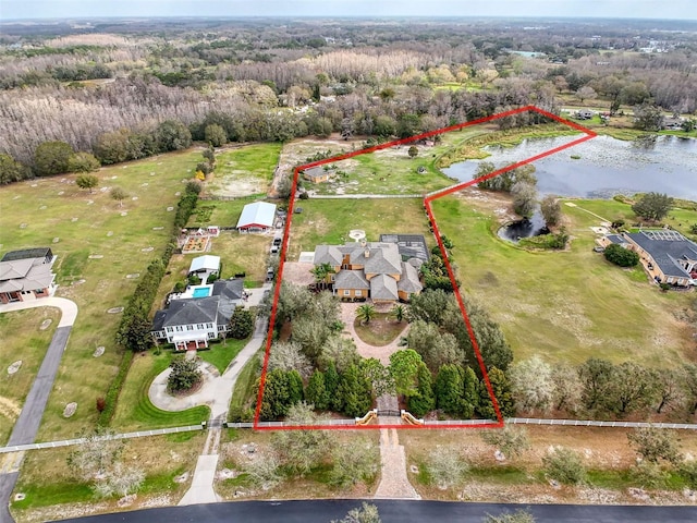 birds eye view of property with a wooded view