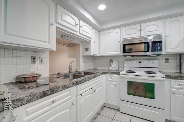 kitchen with white cabinets, electric range, decorative backsplash, and sink