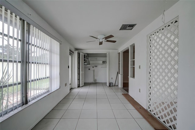 corridor with light tile patterned floors