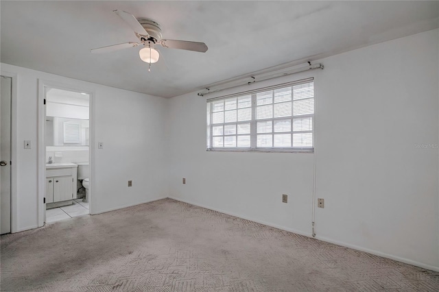 carpeted empty room with ceiling fan