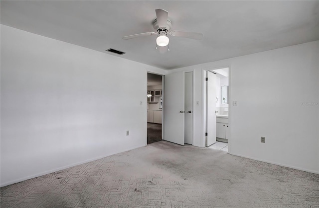 carpeted empty room featuring ceiling fan