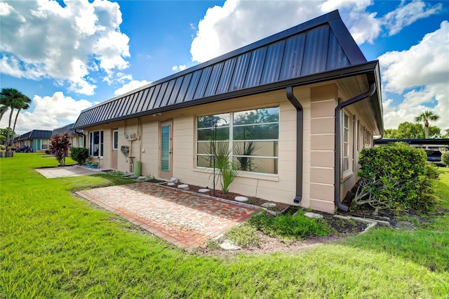 rear view of house featuring a yard