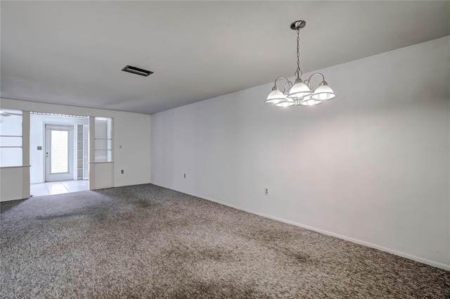 unfurnished room featuring light colored carpet and a notable chandelier