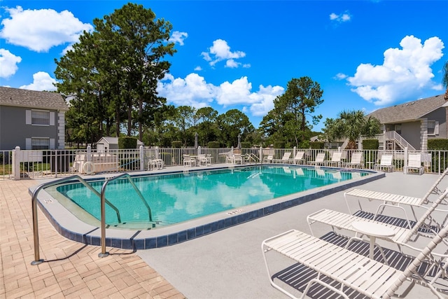 pool featuring a patio area and fence