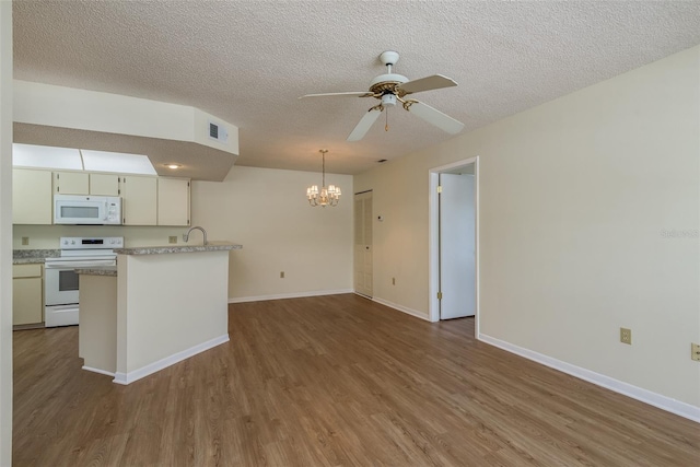 kitchen featuring ceiling fan with notable chandelier, white appliances, wood finished floors, and visible vents