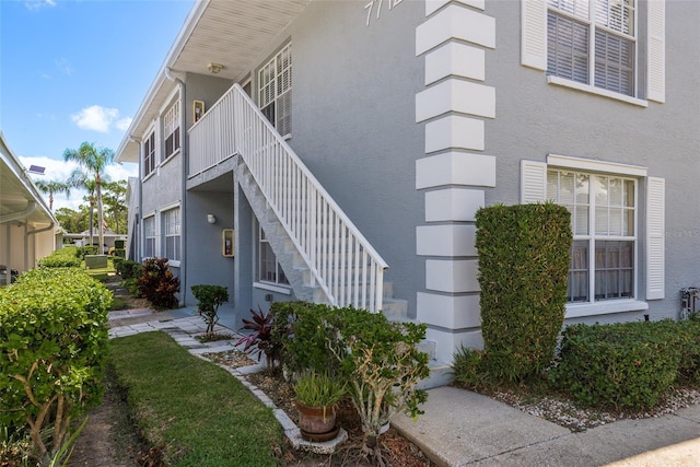 doorway to property featuring stucco siding