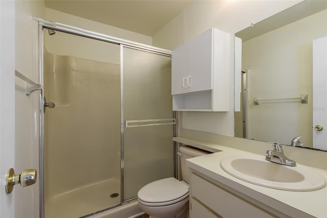 full bathroom with toilet, a stall shower, and vanity