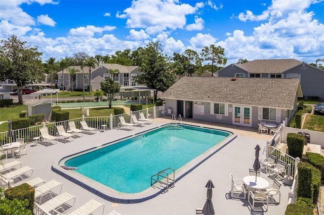7712 Hillside Ct Unit 202, Hudson, FL 34667 - community pool with a patio, french doors, and a residential view