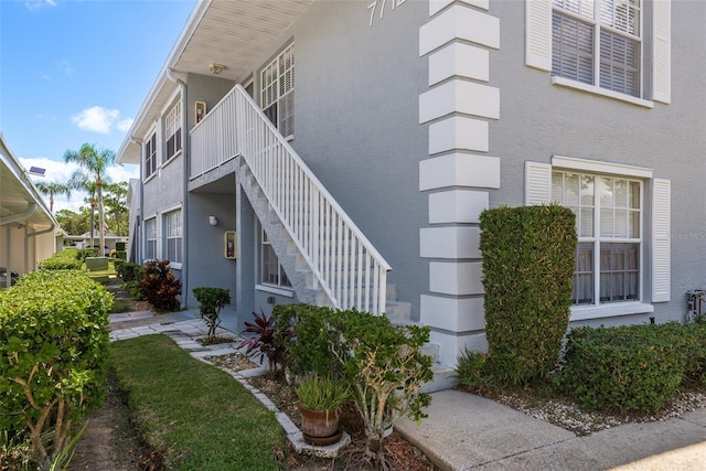 7712 Hillside Ct Unit 202, Hudson, FL 34667 - view of side of home with stucco siding and stairway