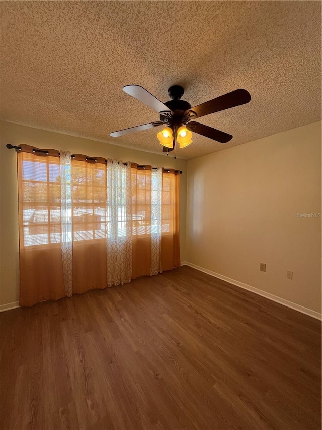 7712 Hillside Ct Unit 202, Hudson, FL 34667 - empty room featuring a textured ceiling, wood finished floors, a ceiling fan, and baseboards