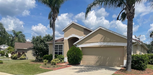 ranch-style house with a garage and a front lawn