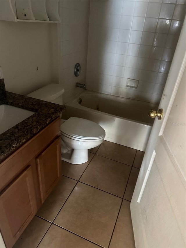 full bathroom with tile patterned floors, vanity, toilet, and tiled shower / bath combo