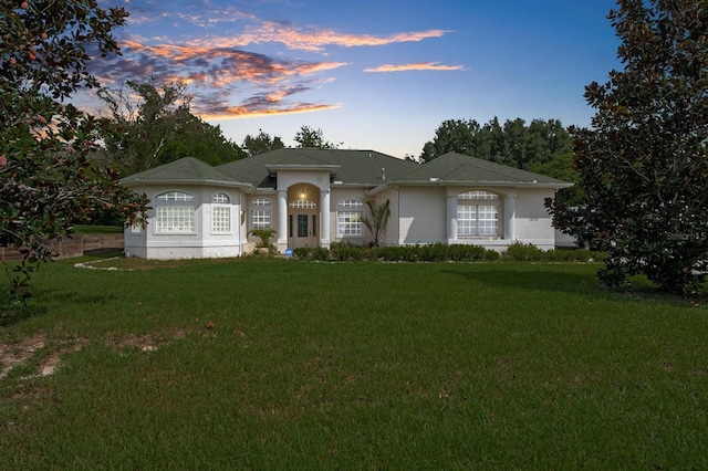 single story home featuring a yard