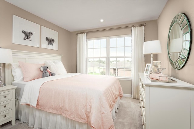 carpeted bedroom featuring multiple windows