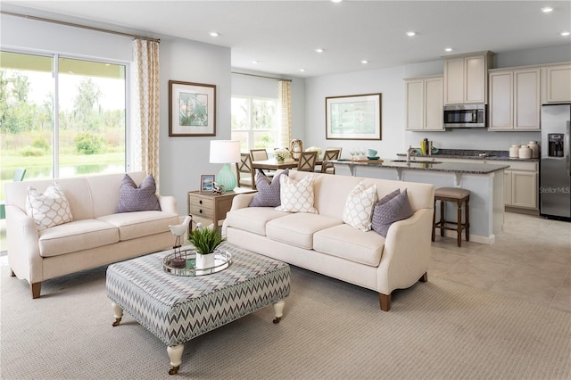 living room with light tile patterned floors and sink