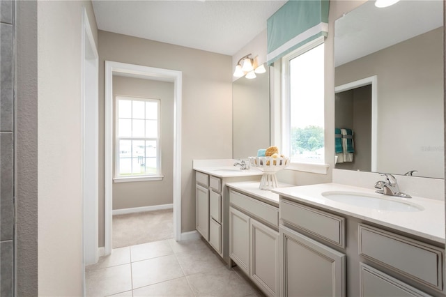 bathroom with tile patterned flooring, plenty of natural light, and vanity