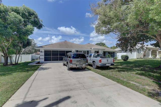 view of front of property with a garage and a front lawn