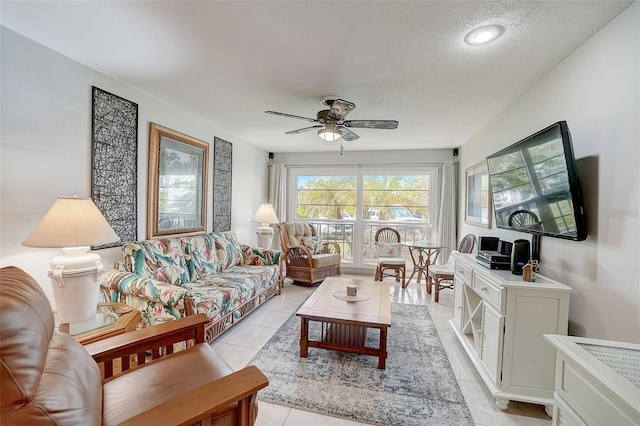 tiled living room with a textured ceiling and ceiling fan