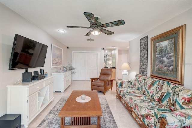 tiled living room featuring a textured ceiling and ceiling fan