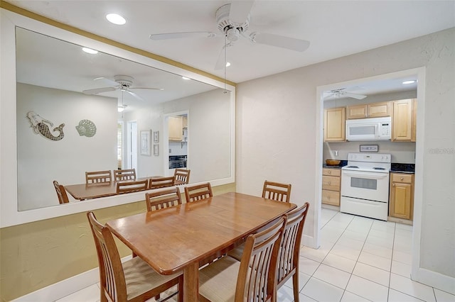 tiled dining space featuring ceiling fan