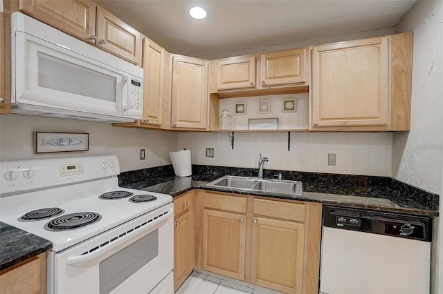 kitchen with white appliances, sink, light brown cabinets, dark stone counters, and light tile patterned flooring