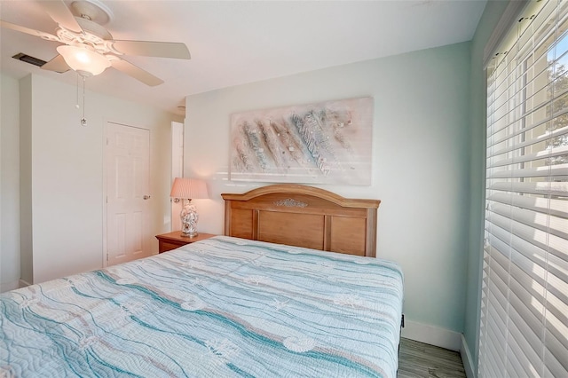 bedroom with ceiling fan and wood-type flooring