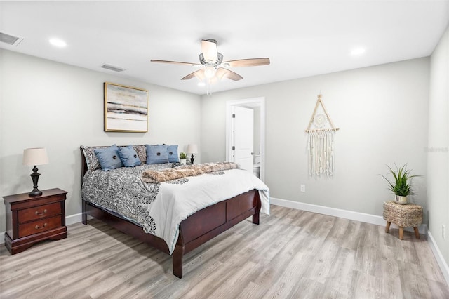 bedroom with ceiling fan, light wood-type flooring, and connected bathroom