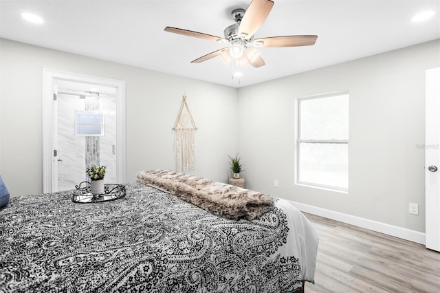 bedroom featuring light hardwood / wood-style flooring, connected bathroom, and ceiling fan