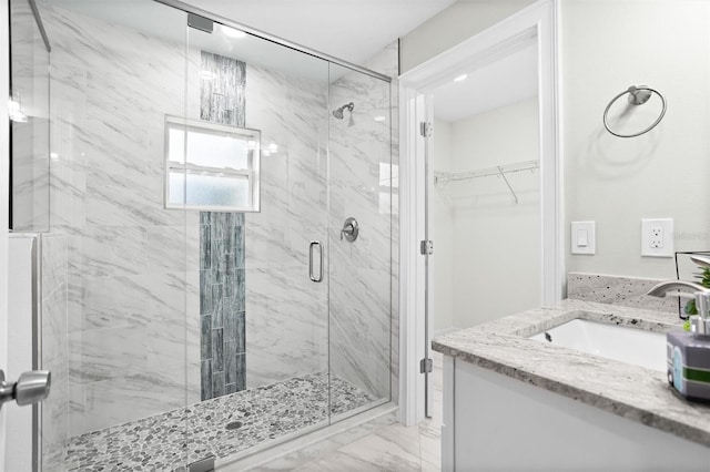 bathroom with walk in shower and vanity